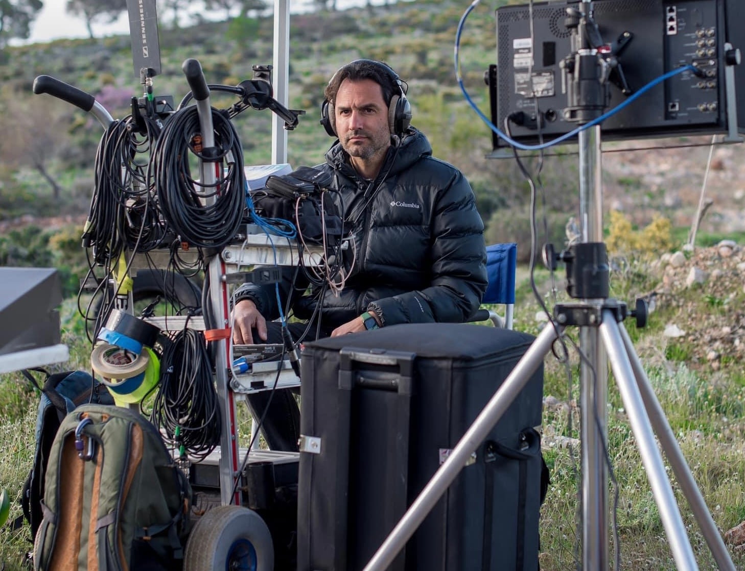 Yannis Antipas monitoring sound beside his location sound cart